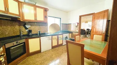 a kitchen with wooden cabinets and a counter top at Villa GP by Sunny Deluxe in Albufeira