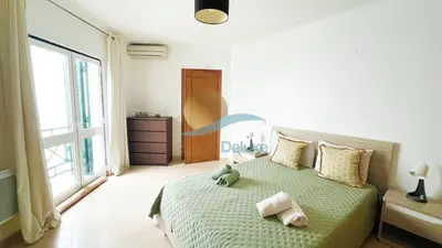 a bedroom with a green bed with a teddy bear on it at Villa GP by Sunny Deluxe in Albufeira