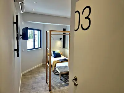 a room with a bedroom with a bed and a mirror at Campus 121 - Rooms in Faro