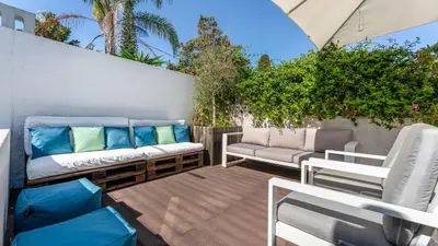 a patio with couches and chairs on a deck at Relaxing Beach House in Alfamar by LovelyStay in Albufeira