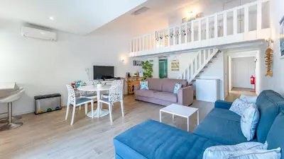 a living room with a blue couch and a table at Relaxing Beach House in Alfamar by LovelyStay in Albufeira