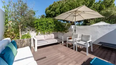 a patio with two chairs and an umbrella at Relaxing Beach House in Alfamar by LovelyStay in Albufeira