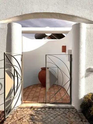 an open door to a patio with a vase at Casa Vale do Lobo in Vale do Lobo