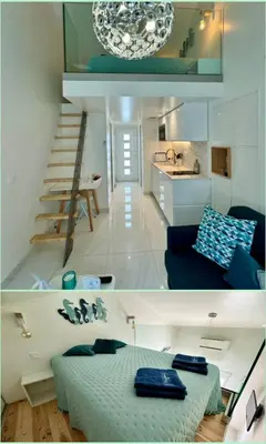 a kitchen with a sink and a tv on the wall at Almar Studio - Albufeira - Praia dos pescadores in Albufeira