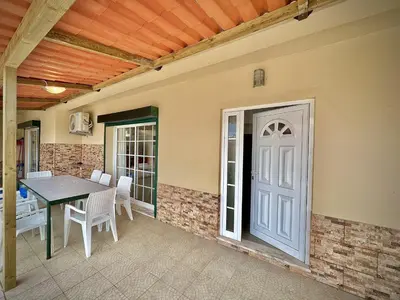 a patio with a table and chairs and a door at Albufeira Summer Villa 2 with Pool by Homing in Albufeira