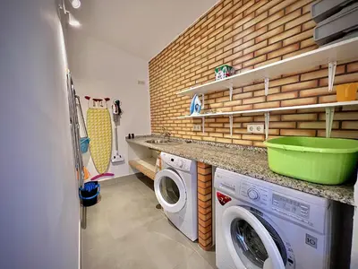 a laundry room with a washer and dryer at Albufeira Summer Villa 2 with Pool by Homing in Albufeira