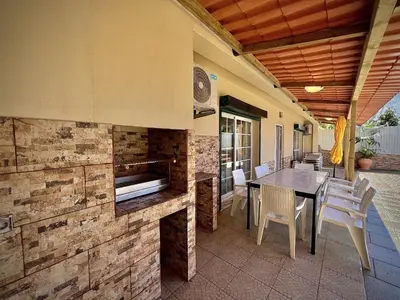 an outdoor patio with a table and a fireplace at Albufeira Summer Villa 2 with Pool by Homing in Albufeira