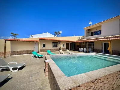 a villa with a swimming pool in front of a house at Albufeira Summer Villa 2 with Pool by Homing in Albufeira