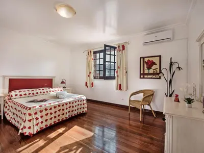 a bedroom with a bed and a table and chairs at Villa Vera VIP Properties by Interhome in Vilamoura