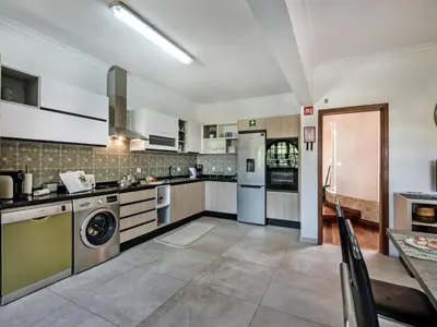 a kitchen with a washer and dryer at Villa Vera VIP Properties by Interhome in Vilamoura