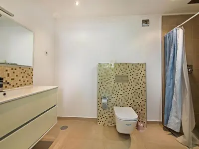 a bathroom with a tub and a sink and a mirror at Villa Nobre - VIP Properties by Interhome in Albufeira