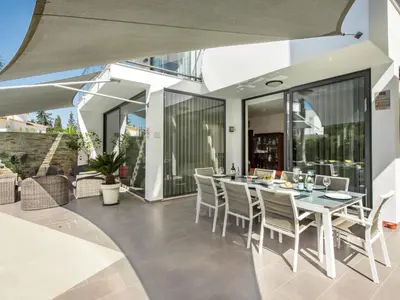 an outdoor dining area with a table and chairs at Villa Nobre - VIP Properties by Interhome in Albufeira