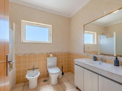 a bedroom with a large white bed with a window at Villa Carmen by Interhome in Terras Novas