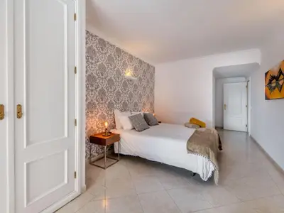 a bedroom with a bed and a table with a candle at Apartment T2 Cassias VIP Properties by Interhome in Vilamoura
