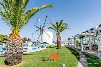 a group of palm trees next to a pool at #220 Windmill Hill by Home Holidays in Albufeira