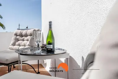 a bottle of wine on a table with a glass at #220 Windmill Hill by Home Holidays in Albufeira