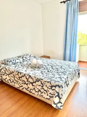 a bedroom with a bed with a black and white blanket at Apartamento Faro - T3 in Faro