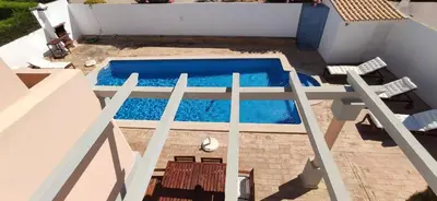 an overhead view of a swimming pool in a backyard at Casa Golfinho, Albufeira in Albufeira
