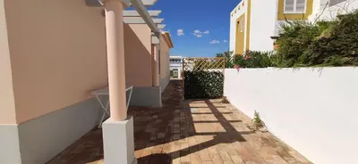 a hallway of a house with a white wall at Casa Golfinho, Albufeira in Albufeira