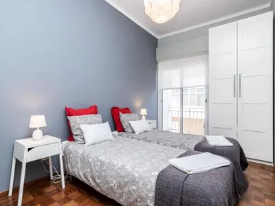 a bedroom with a large bed and a window at Akisol Faro Sunny in Faro