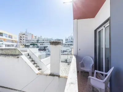 a balcony with two chairs and a view of a city at Akisol Faro Sunny in Faro