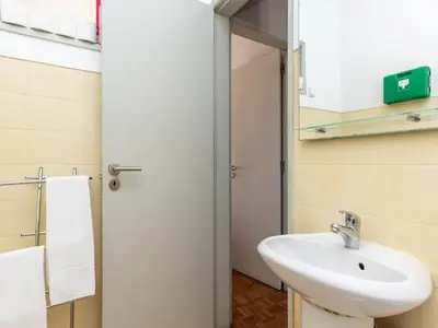 a bathroom with a white sink and a mirror at Akisol Faro Sunny in Faro