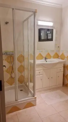 a bathroom with a shower and a sink at FERIAS NA PRAIA in Albufeira