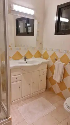 a bathroom with a sink and a mirror and a toilet at FERIAS NA PRAIA in Albufeira