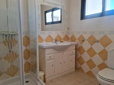 a bathroom with a sink and a shower at FERIAS NA PRAIA in Albufeira