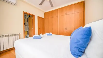 a bedroom with a large white bed with blue pillows at Villa Dolce Vita by Algarve Vacation in Albufeira