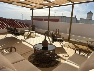 a patio with a table and chairs on a roof at CASA NOAVA in Loulé