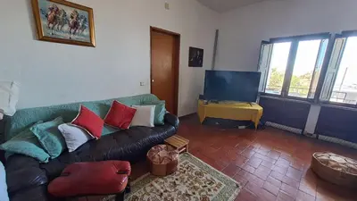 a living room with a couch and a television at Albufeira Seaview 4 Beach HOUSE in Albufeira