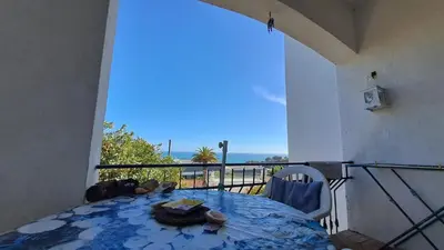 a balcony with a table and a view of the ocean at Albufeira Seaview 4 Beach HOUSE in Albufeira
