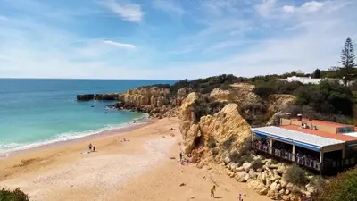 an overhead view of a beach with a building at Albufeira Seaview 4 Beach HOUSE in Albufeira