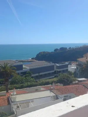 a view of a building with the ocean in the background at Albufeira Seaview 4 Beach HOUSE in Albufeira
