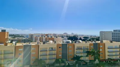 a view of a city with buildings and palm trees at Al Charb TopFloor sea view, ar con, pool - CleverDetails in Vilamoura