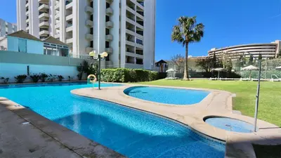 a swimming pool in front of a building at Al Charb TopFloor sea view, ar con, pool - CleverDetails in Vilamoura