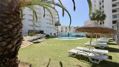 a group of white lounge chairs and an umbrella at Al Charb TopFloor sea view, ar con, pool - CleverDetails in Vilamoura