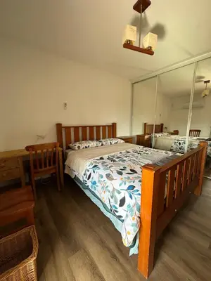 a bedroom with a bed and a large mirror at Casa Amarela in Faro
