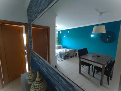 a living room with a table and a bedroom at Lovely 2 Bedroom S Jose Apartment in Albufeira