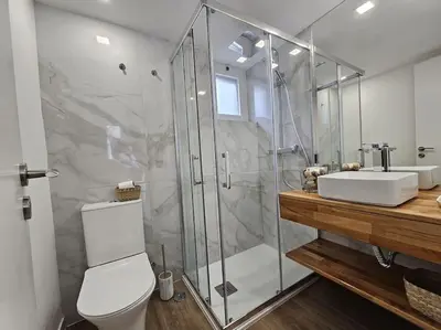 a bathroom with a shower and a toilet and a sink at Casa da Aldeia in Olhos de Água