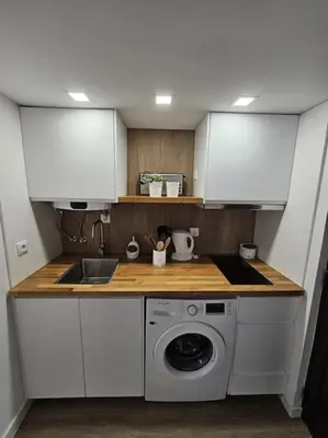a kitchen with a sink and a washing machine at Casa da Aldeia in Olhos de Água
