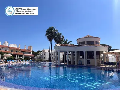 a large swimming pool at a resort with a building at Old Village, 2 bedrooms, 5 ppl, Beach, Golf, Padel in Vilamoura