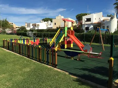 a playground with a slide in a park at Old Village, 2 bedrooms, 5 ppl, Beach, Golf, Padel in Vilamoura