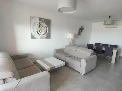 a living room with a couch and a table at Luxury apartment in Vitismar condo view sea & pool in Galé