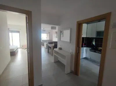 a room with a kitchen and a living room at Luxury apartment in Vitismar condo view sea & pool in Galé
