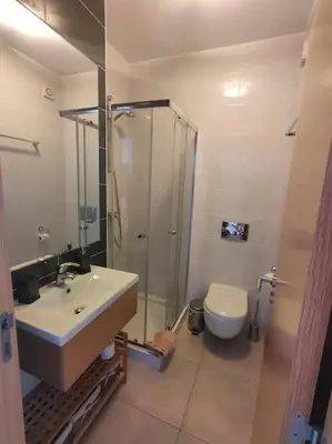 a bathroom with a sink and a shower and a toilet at Luxury apartment in Vitismar condo view sea & pool in Galé