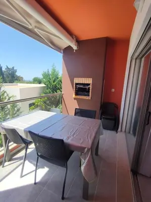 a balcony with a table and chairs on a balcony at Luxury apartment in Vitismar condo view sea & pool in Galé