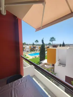 a room with a balcony with a view of a pool at Luxury apartment in Vitismar condo view sea & pool in Galé