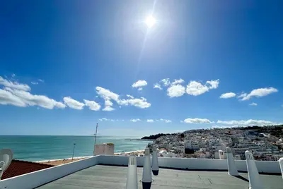 a view of the beach from the balcony of a house at Casa Esperança in Albufeira